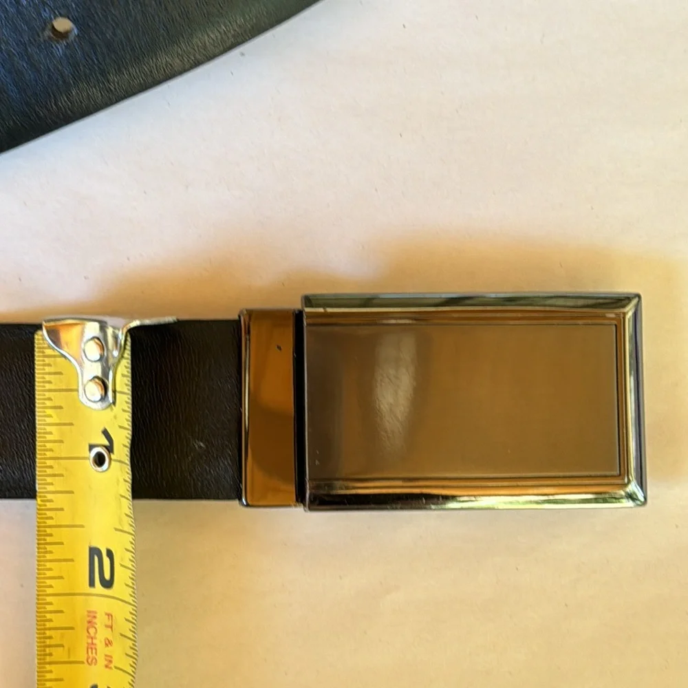 Black leather belt with pewter toned belt buckle. Black. Size 42.